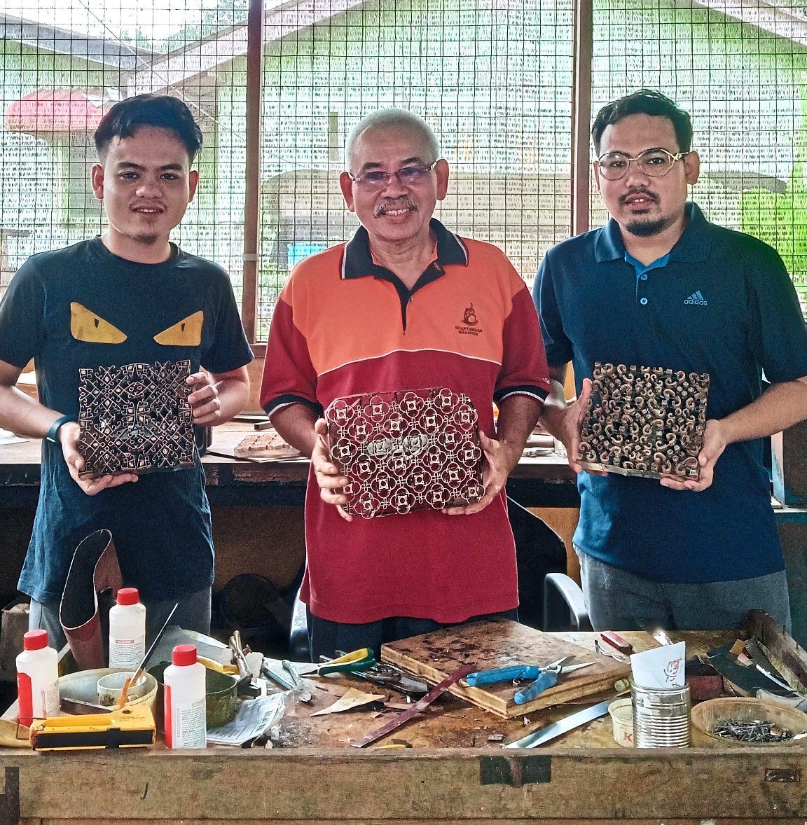 Md Ghani (centre) is happy to pass his expertise down to Mohd Eri (right) and Mohd Ahmad.