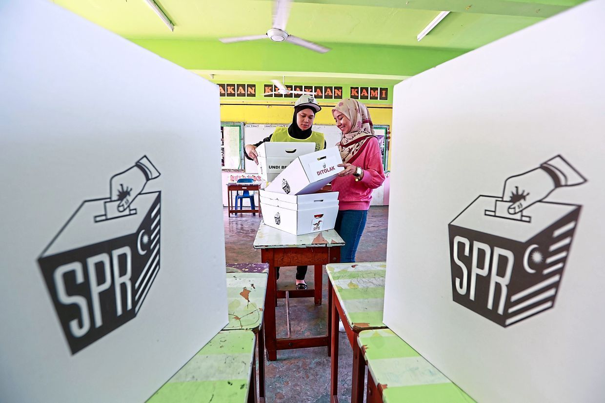 Election Commission workers arranging ballot boxes at the SK Bintulu polling station in preparation for the Jepak by-election. - ZULAZHAR SHEBLEE / The Star
