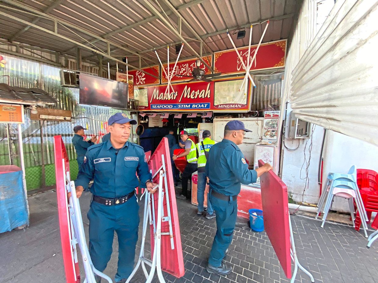 PLS BLUR out the SIGNBOARD (arabic words and name)DBKL officers removing the chairs and tables during the operation in Chinatown on Saturday.