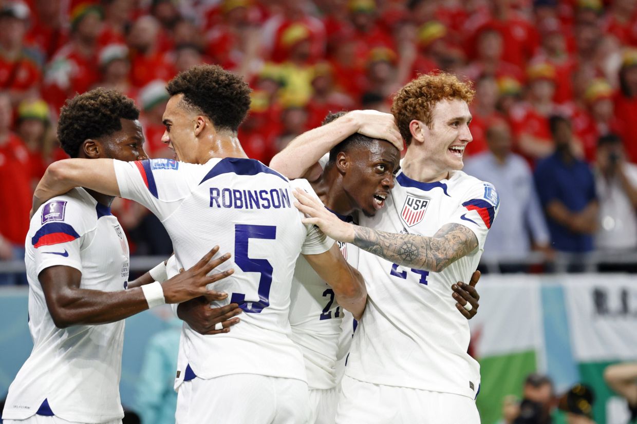 Nov 21, 2022; Al Rayyan, Qatar; United States of America forward Josh Sargent (24) congratulates forward Timothy Weah (21) after he scored a goal Wales during the first half during a group stage match during the 2022 FIFA World Cup at Ahmed Bin Ali Stadium. Mandatory Credit: Yukihito Taguchi-USA TODAY Sports