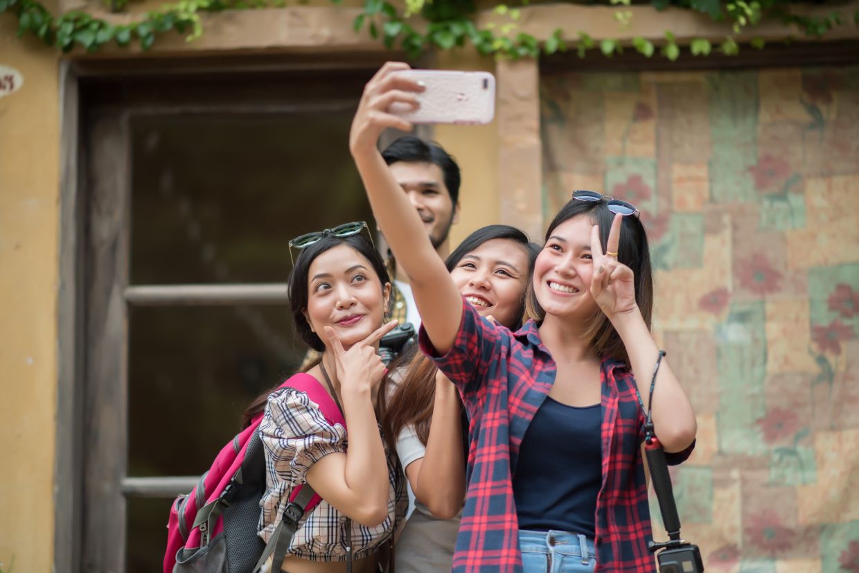 Group of friends taking selfie in a urban street having good fun together.