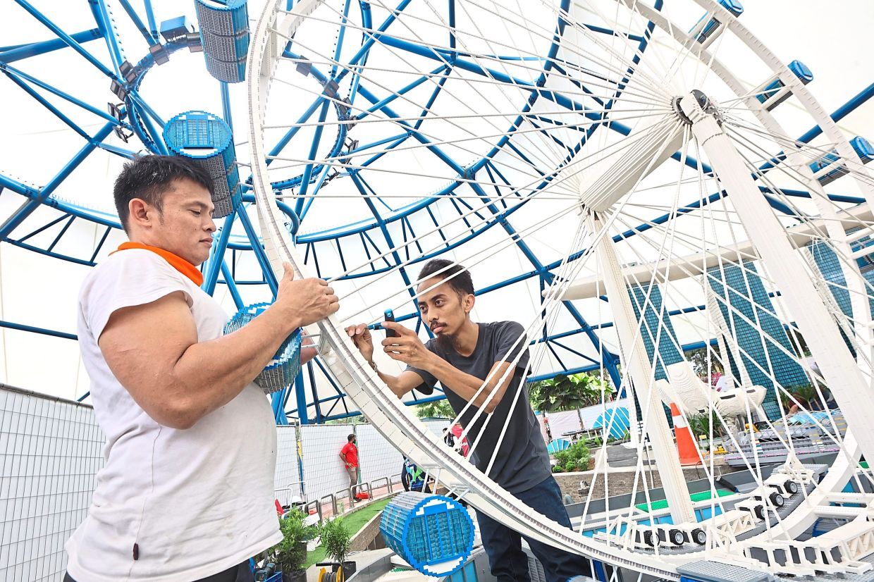The Merlin Magic Making (MMM) team installs the Singapore Flyer replica with due care and close attention to safety, ensuring a secure and seamless addition to the new miniland expansion at Legoland Malaysia. — THOMAS YONG/The Star