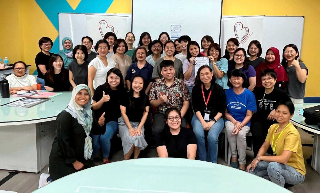 Mathematician Dr Fu Sai Hoe (seated third left) posed for the camera during one of his Maths masterclasses with teachers.