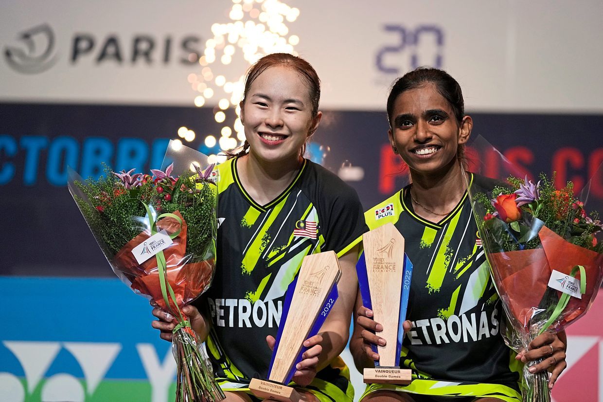 Pearly Tan, left, and Thinaah Muralitharan of Malaysia react after defeating Mayu Matsumoto and Wakana Nagahara of Japan during the trophy ceremony of their women's doubles final of the Yonex French Open Badminton at Coubertin Stadium, in Paris, France, Sunday, Oct. 30 , 2022. (AP Photo/Francois Mori)