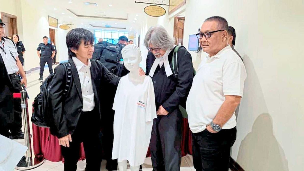 Lawyers Joan Goh (left) and Datuk Ram Singh (second from right) with the mannequin before the Coroner court proceeding in Kota Kinabalu