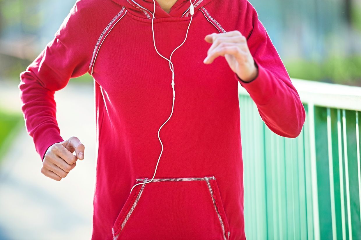 Torso of young female model running on the bridge during everyday practice. Fitness woman jogging outdoors in park. Sport active lifestyle concept. Close-up view
