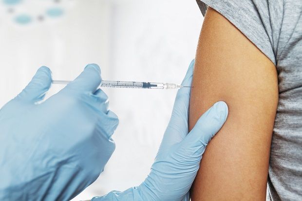 Nurse makes vaccination in the shoulder of patient in a clinic