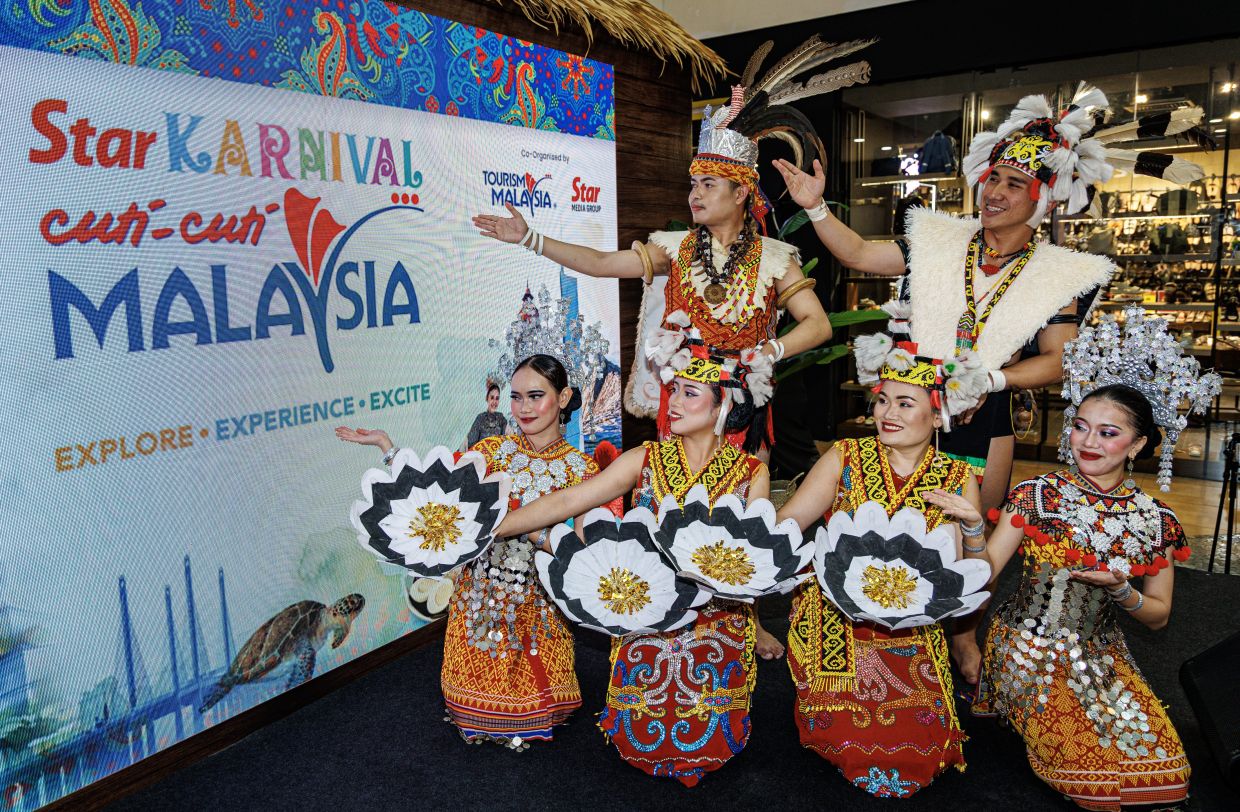 A performer from the Sarawak Cultural Village flashes a graceful pose after captivating the crowd with a traditional dance during the Star Karnival Cuti-Cuti Malaysia at Plaza Merdeka, Kuching a vibrant showcase of culture, colours, and community spirit.— ZULAZHAR SHEBLEE/The Star