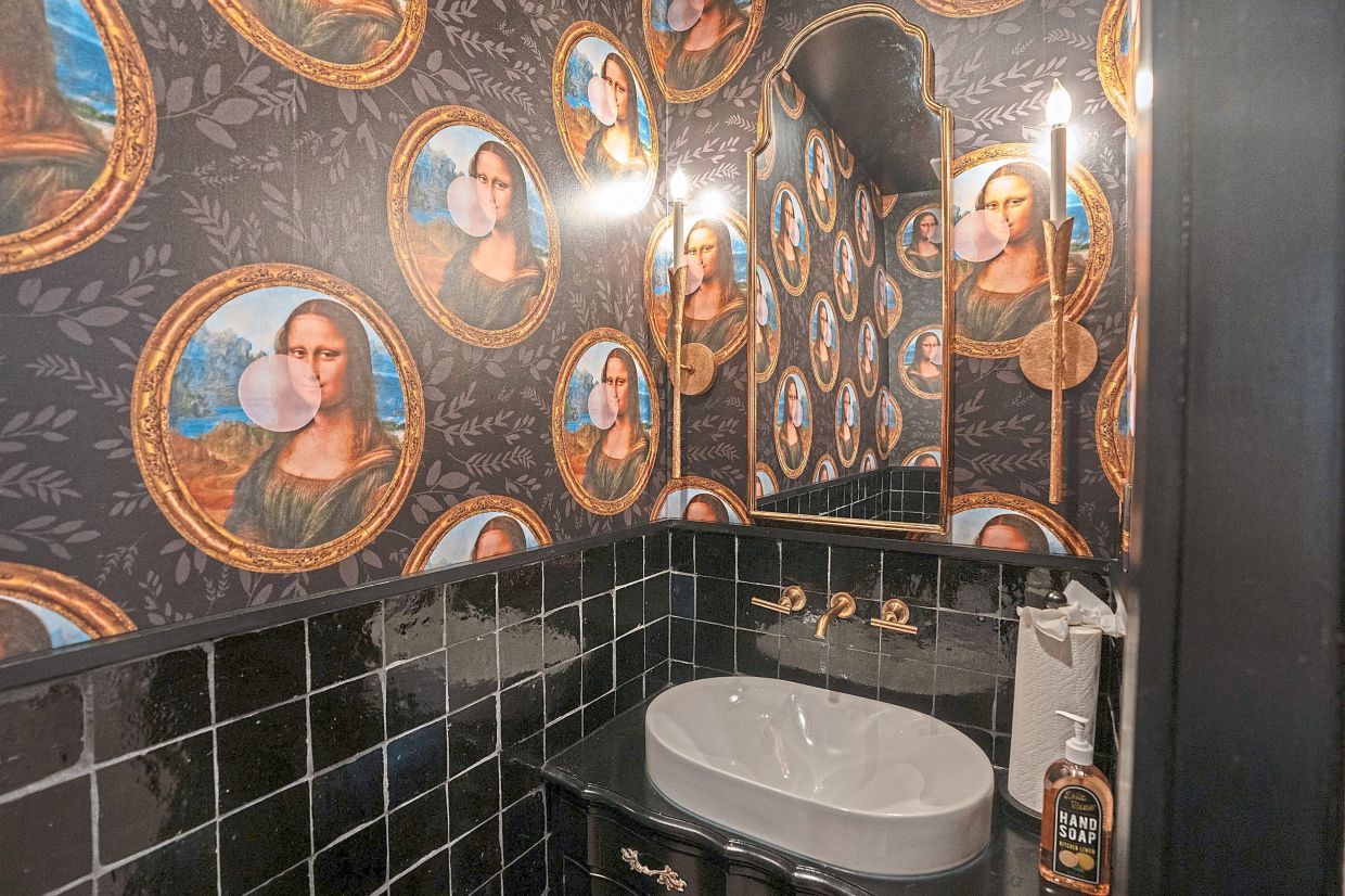 A renovated bathroom in Justine Mays' Upper Darby home features the Mona Lisa blowing pink bubbles.