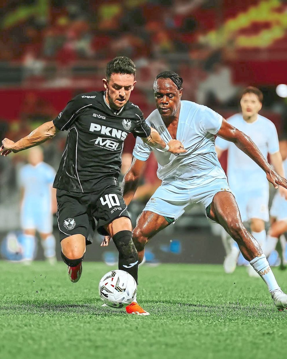 Zach Clough (left) tries to evade the attentions of Asia Warriors’ Victor Igbonefo. - Photo by Selangor FC