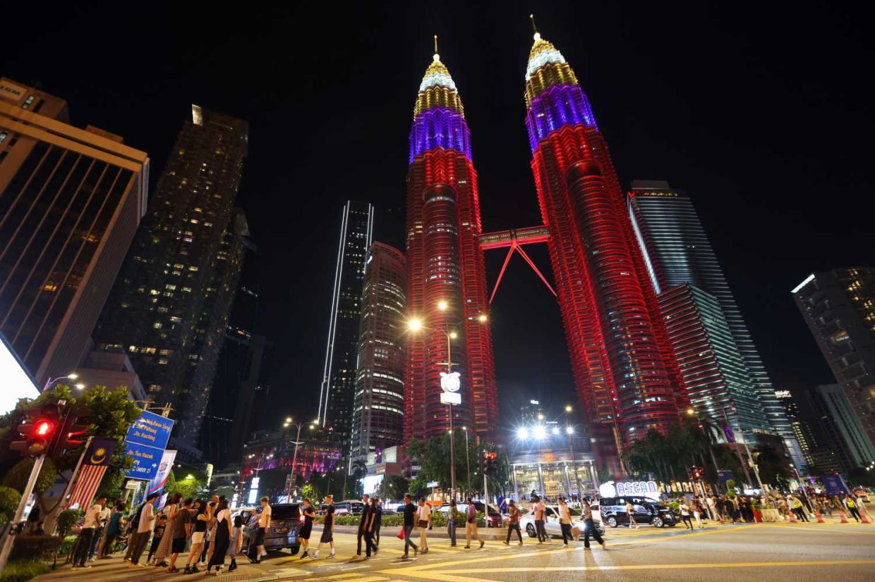 The Petronas Twin Towers lighted up in the colors of Malaysian flag in conjunction with the Asean Summit in Kuala Lumpur, October 27, 2025. — GLENN GUAN/The Star