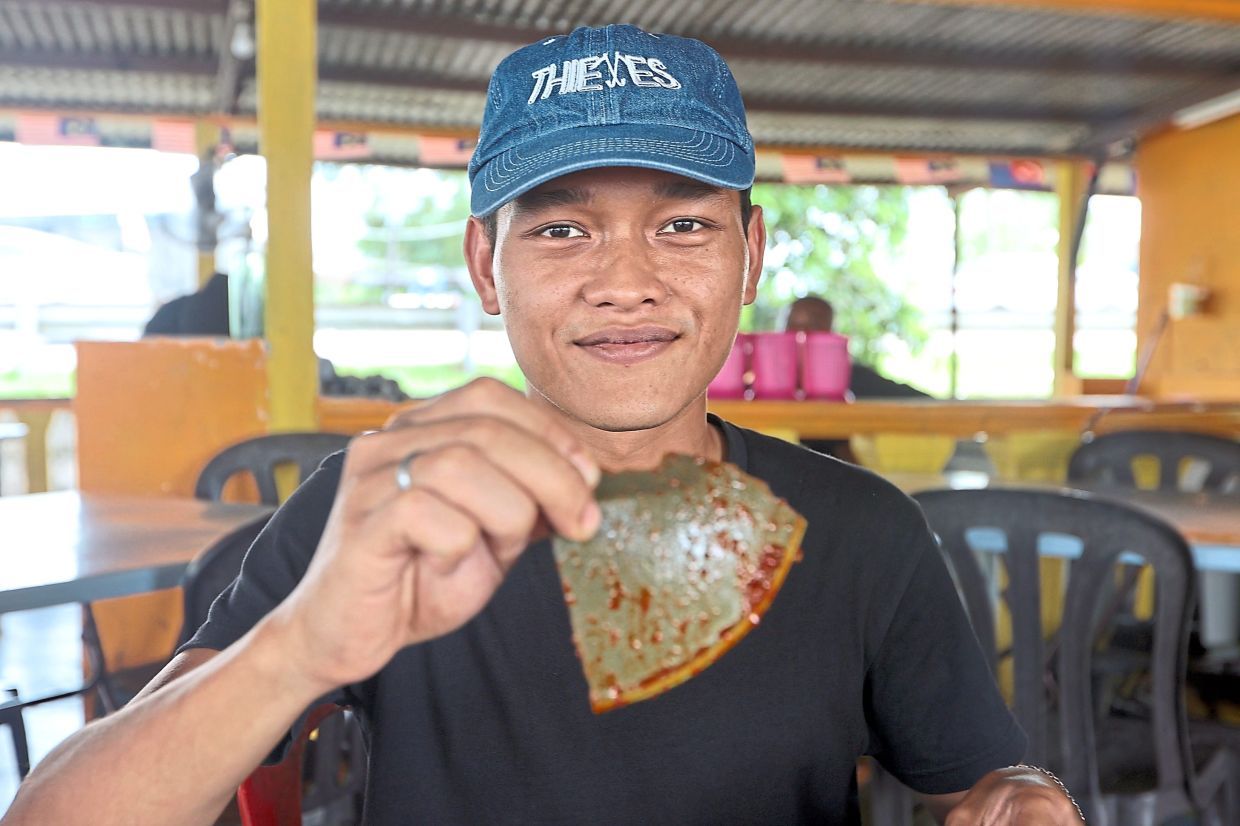 Retail assistant Mohamad Dary Irsyad, 25. — THOMAS YONG/The Star