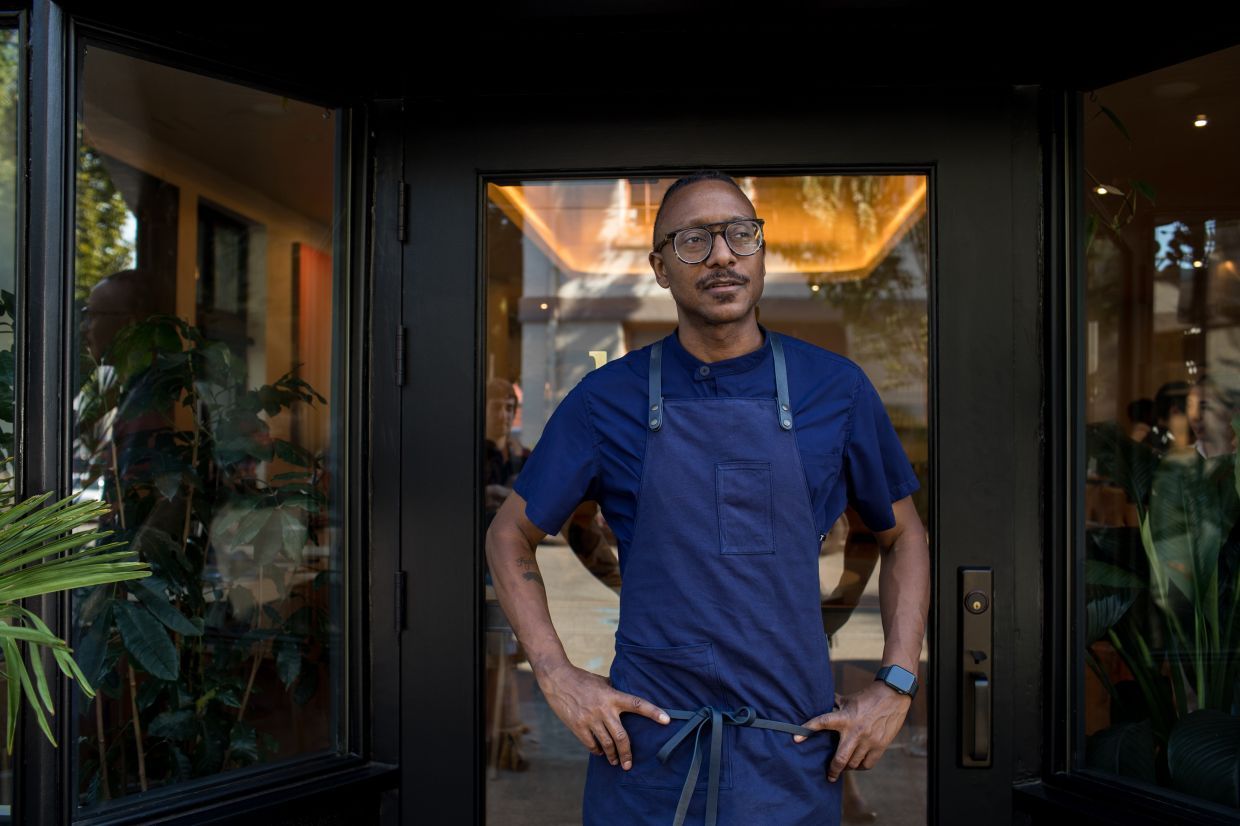 FILE — The chef Gregory Gourdet outside Kann, where Haitian wood-fired cooking meets ingredients influenced by Oregon’s seasonal bounty, in Portland, Aug. 25, 2022. Gourdet, a former contestant on “Top Chef,” said Michelin stars can bring some of the renown television appearances used to.(Celeste Noche/The New York Times)