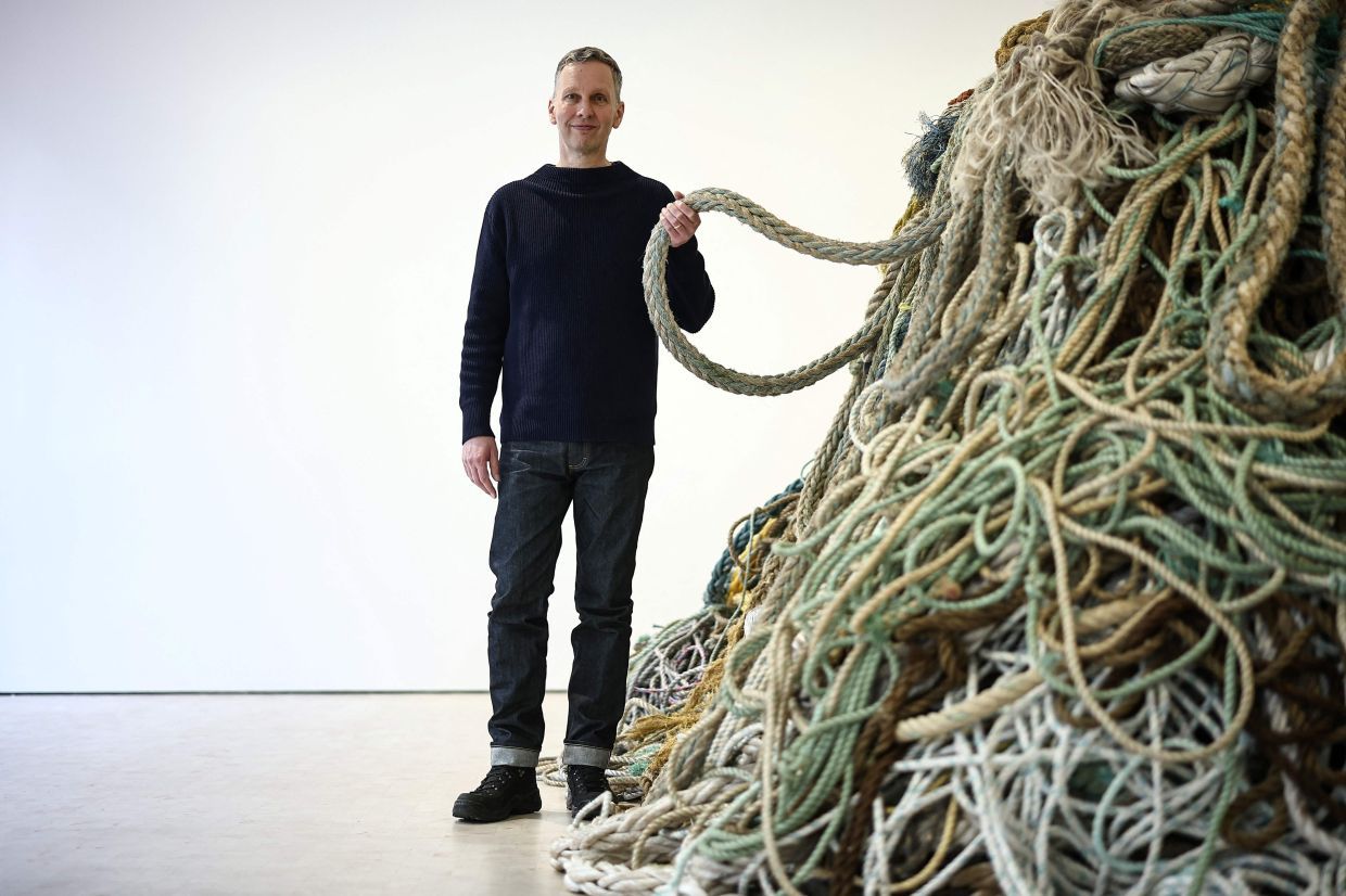 British artist David Shrigley poses next to his installation