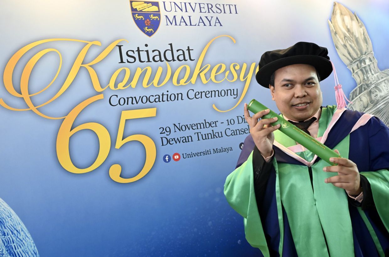 Blind candidate, Dr. Noorilham Ismail, after receiving his PhD accreditation in Humanities, History & Archealogy at the Convocation Ceremony of Universiti Malaya. — RAJA FAISAL HISHAN/The Star