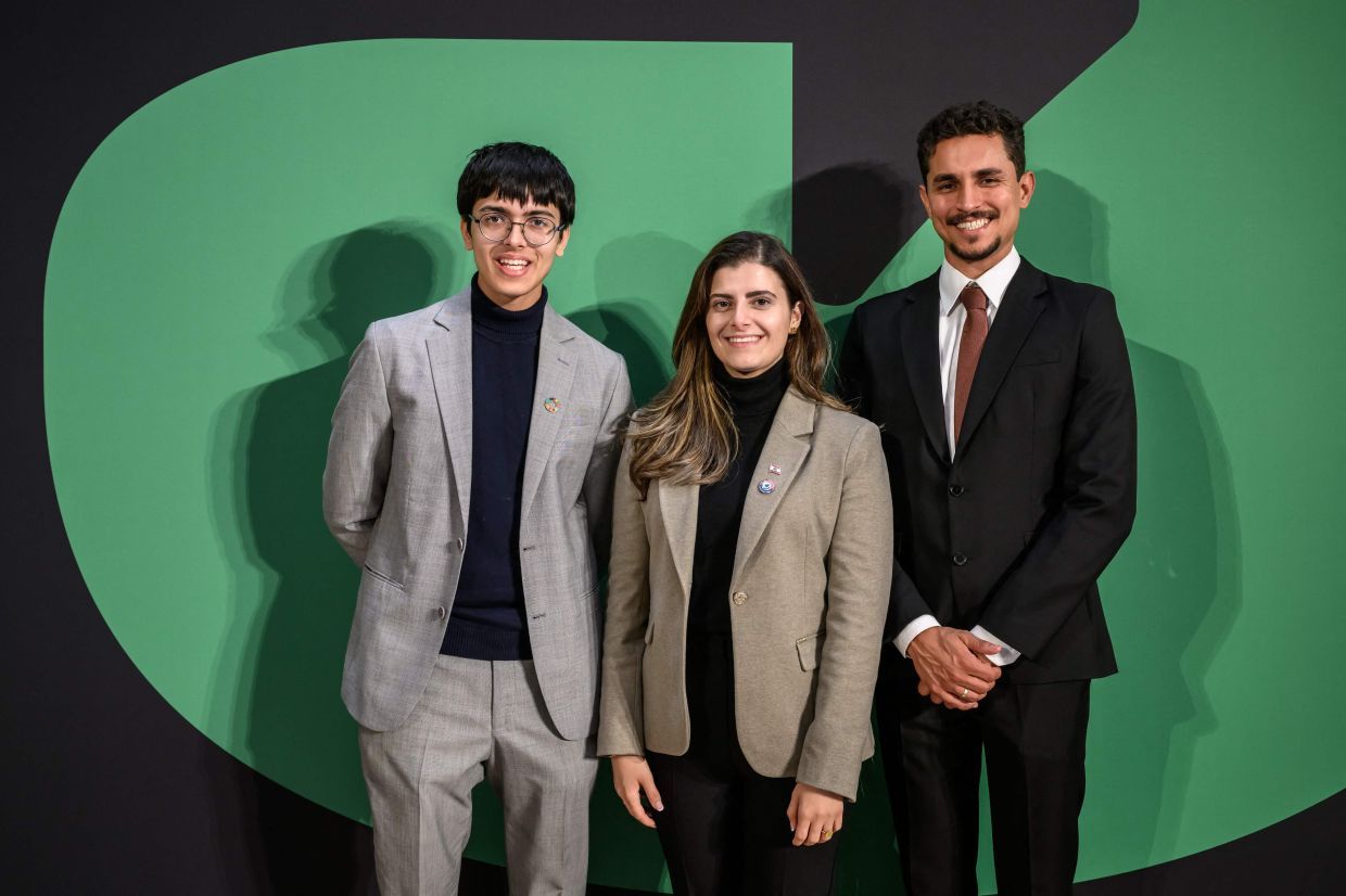 (From L) Young activists India's Dev Karan, Lebanon's Marina El Khawand and Brazil's Salvino Oliveira pose on the eve of the Young Activists Summit award ceremony at the UN in Geneva, on November 19, 2025. Five youths using tech to drive change win United Nations-backed prize. (Photo by Fabrice COFFRINI / AFP)