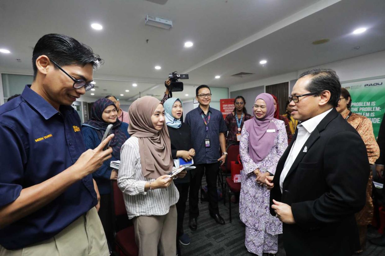 Education ministry director general Dr Mohd Azam Ahmad sharing a light moment with members of the media.—SAMUEL ONG/The Star