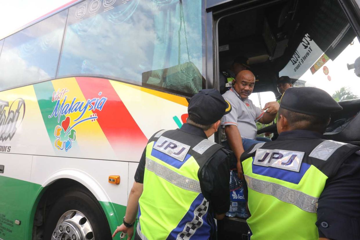 Pengarah JPJ WPKL Hamidi Adam checking a tourist bus carring a MRSM student inside during a Special Operations in Conjunction with the Eid al-Adha Celebration. — AZLINA ABDULLAH/The Star