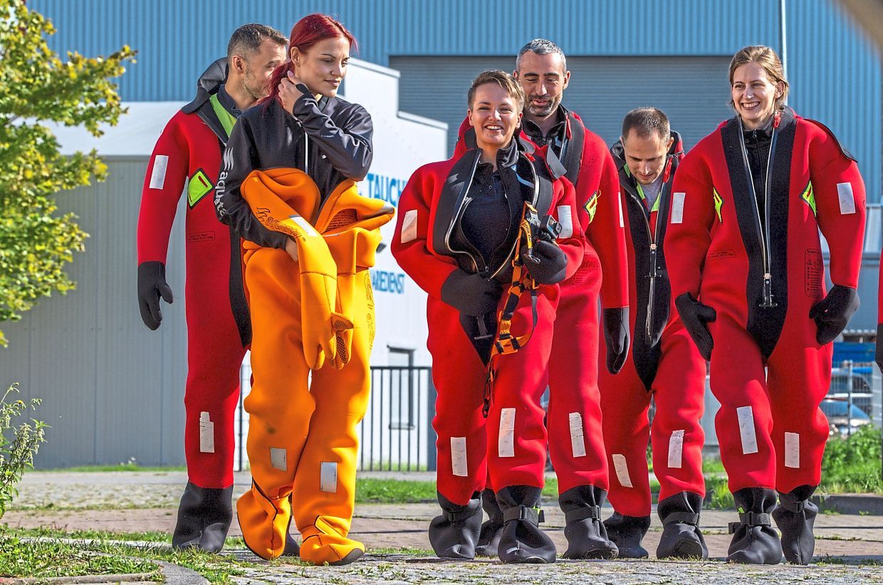 FILED - Amelie Schönenwald, seen in the centre, is wearing a survival suit during a training session with other potential European Space Agency astronauts. Schönenwald, who is German, is training with seven others from a total of seven European countries. Photo: Jens Büttner/dpa