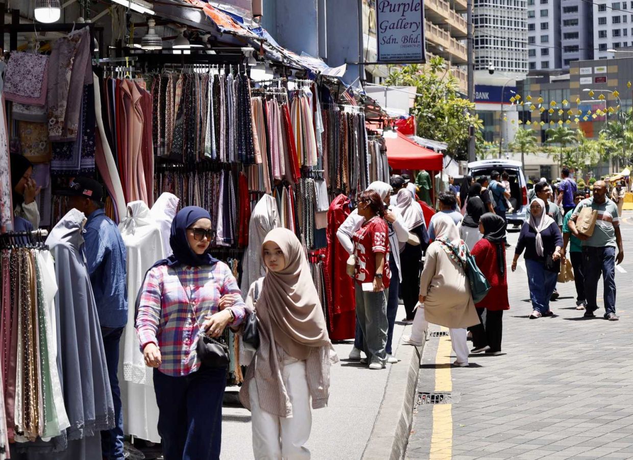 Family shopping for upcoming Hari Raya celebration at Bazar Aidilfitri Lorong TAR, Kuala Lumpur. — FAIHAN GHANI/The Star