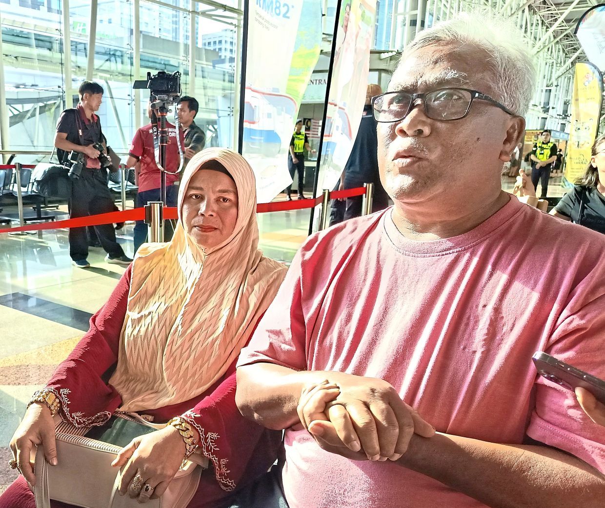 Halim Said sharing his experience with the press (right). Looking on is his wife Noor Aini Senawi (left)