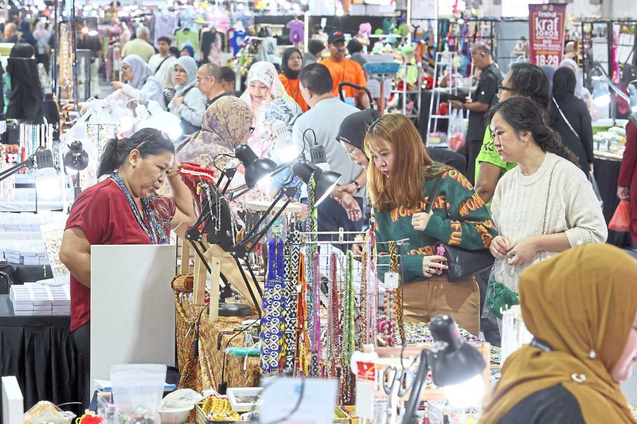 Visitors and shoppers exploring a variety of craft products. — THOMAS YONG/The Star