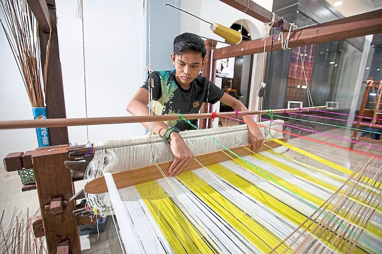 Kain Benang Johor weaver Mohamad Sharil Ahmad, 23, showing his weaving skills. - Courtesy pix